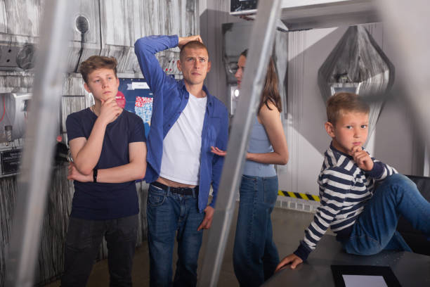 istock Family solving riddles in escape room stylized as underground shelter 1321539944