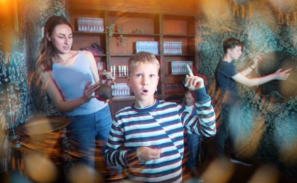 istock Smart preteen boy gesturing with forefinger in quest room 1321540004