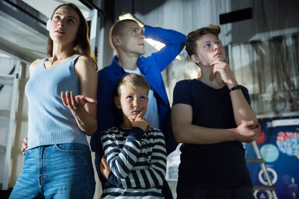 istock Interested family contemplating solving conundrums in escape room 1321540036