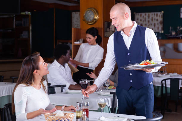 istock smiling waitress bringing order to female client in cafe 1321541527