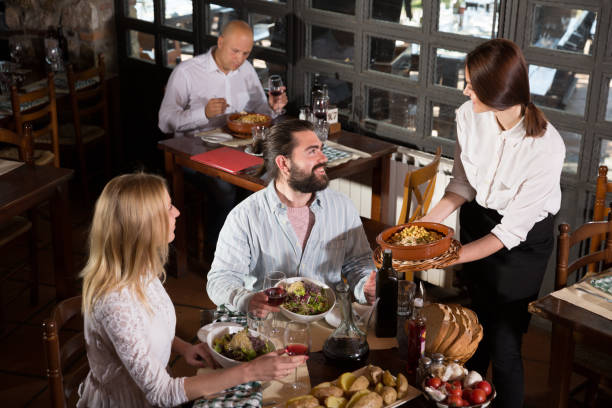 istock Waitress bringing meals to visitors 1321543345