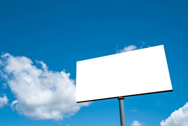 istock White tabloid against a blue sky with beautiful clouds. 1321543491
