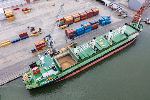 Aerial view of a large cargo ship loading grain.
