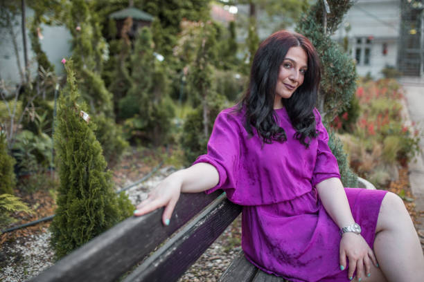 Young beautiful woman sitting on bench in the park