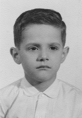 Vintage image from the 60s of a serious pensive little boy headshot (taken at a public automatic coin public photo booth)