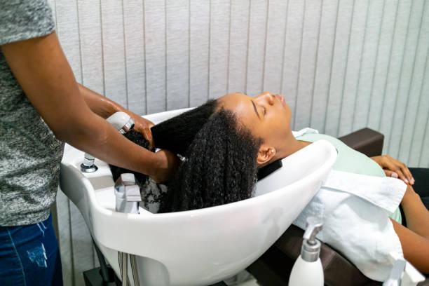 Hair stylist in Brazil. Photo of two brazilian woman. A client and a hair stylist. black woman washing hair stock pictures, royalty-free photos & images