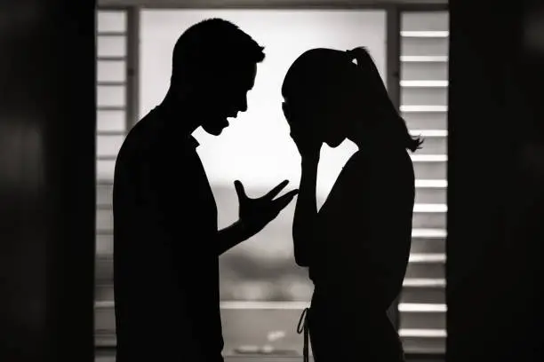 Photo of Argument. Man and woman having an argument at home.
