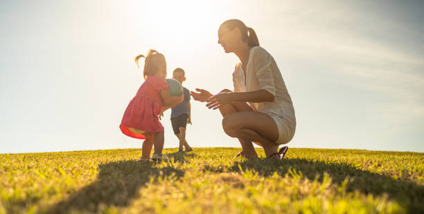 istock Mother playing with her kids in the park. 1321546698