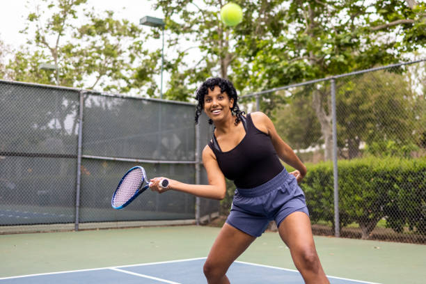 istock Young Black Woman Playing Tennis with Her Friend 1321546830
