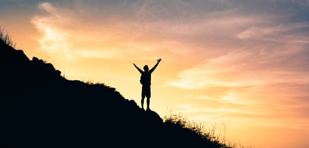 istock Male hiker standing outdoors with arms wide open. 1321547269