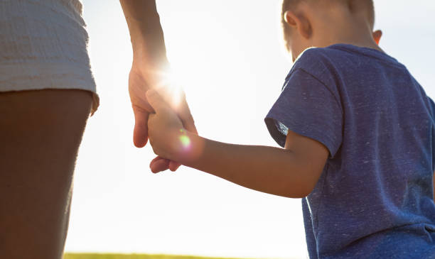 istock Mother and son holding hands 1321547401