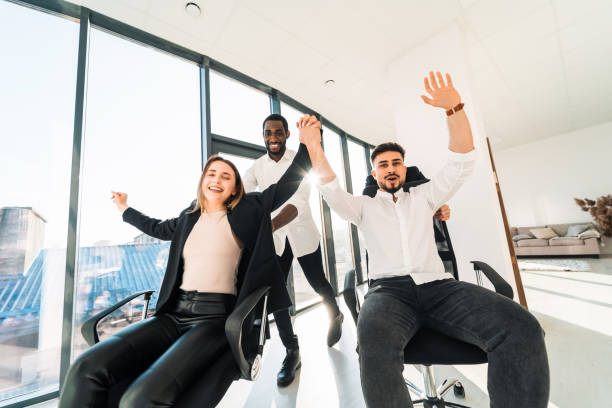 istock Happy multiracial IT workers ride chairs in the office 1321548446