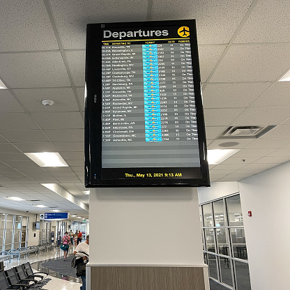 Sanford, FL USA - May 13, 2021:  Departure board monitor at Sanford International Airport in Sanford, Florida.