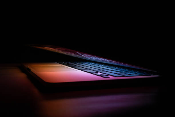 istock a laptop in the dark from the corner 1321551304
