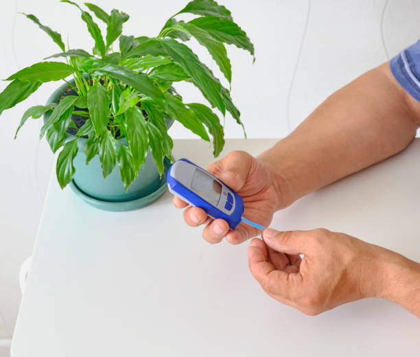 istock Hands of older man checking blood sugar level 1321552268
