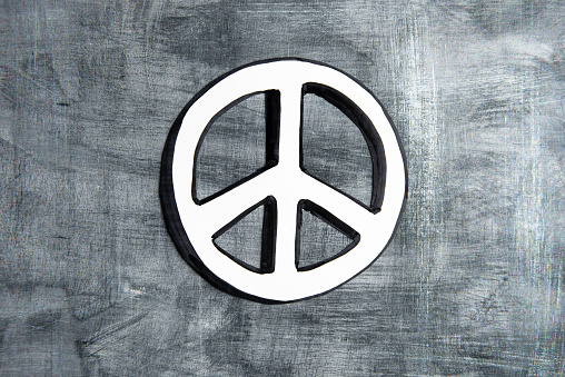 Peace symbol on the gray canvas background.