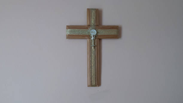 istock wooden cross of Christ placed on white wall 1321553610