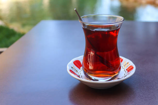 istock Turkish tea in traditional cup in a street restaurant. Close-up, selective focus, copy space 1321556770