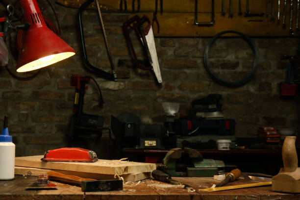 istock Workshop with tools on the wooden table and turned lamp 1321557292