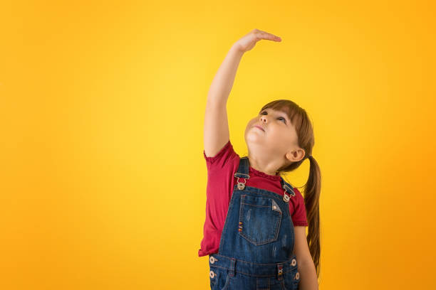 istock Girl checking how tall she's grown 1321558775