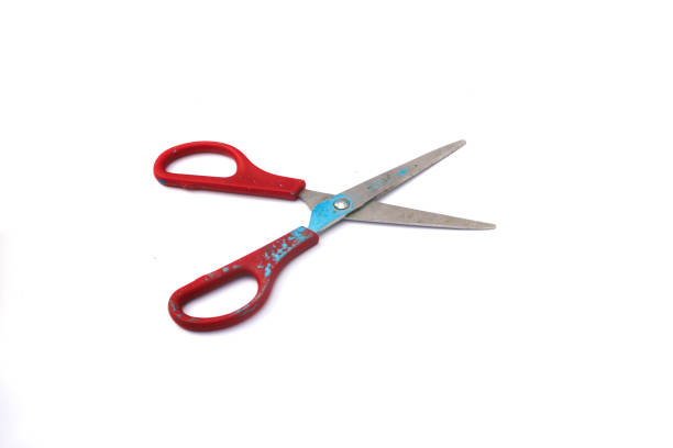 istock Red used scissors with paint splatter isolated on white background 1321559029