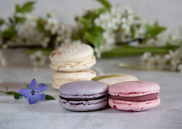 istock Several macaroons lie on the table decorated with flowers. 1321560277