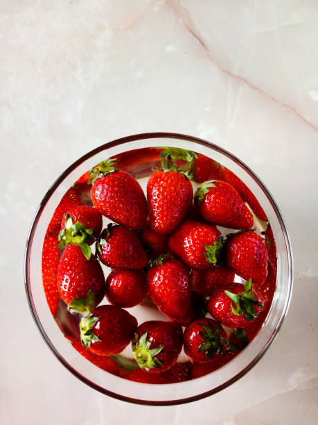istock strawberries in a transparent plate on the kitchen table 1321560463