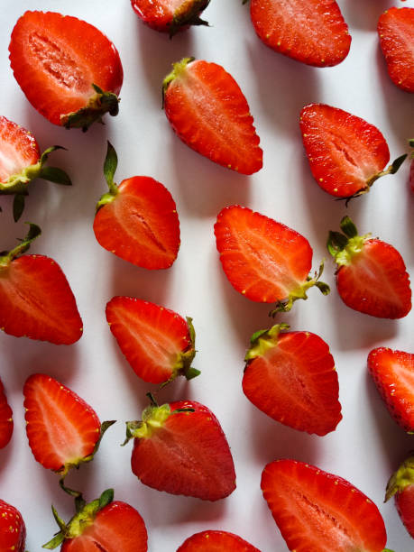 istock strawberries cut in half on a white background 1321560548