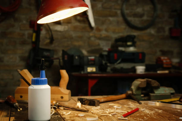 istock Workshop with tools on the wooden table and turned lamp 1321560691