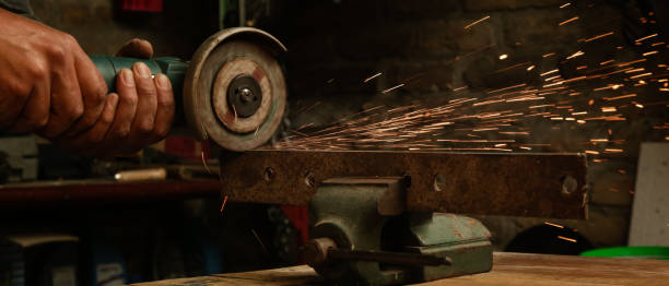 istock Handyman is cutting metal with grinder 1321561892