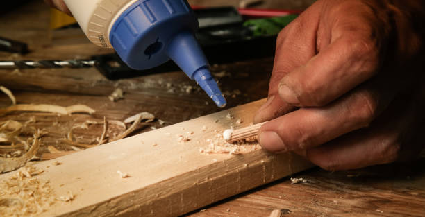 istock Handyman assembling wooden pieces with a glue 1321562758