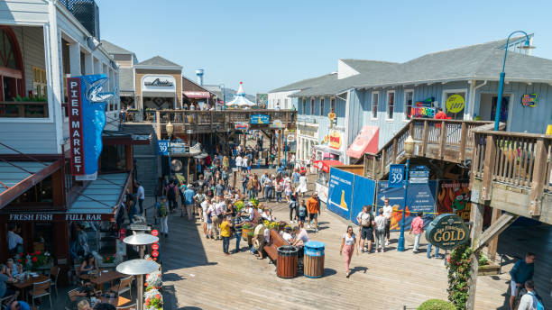 Fisherman's Wharf full of tourists visiting and shopping, San Francisco, California San Francisco, California, USA - August 2019: Fisherman's Wharf full of tourists visiting and shopping fishermans wharf stock pictures, royalty-free photos & images