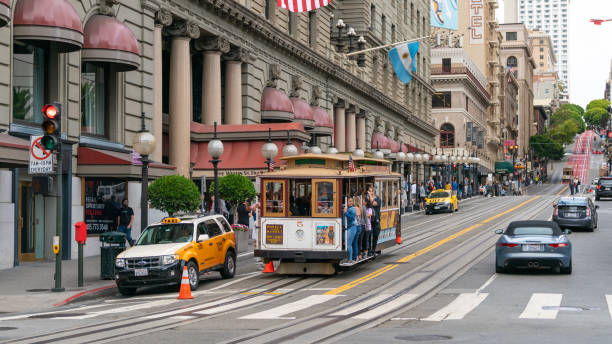 people riding the cable car in san francisco, california, usa - lombard street city urban scene city life imagens e fotografias de stock