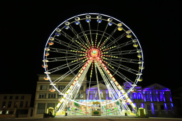 istock Bright ferris wheel illuminated at night 1321565319
