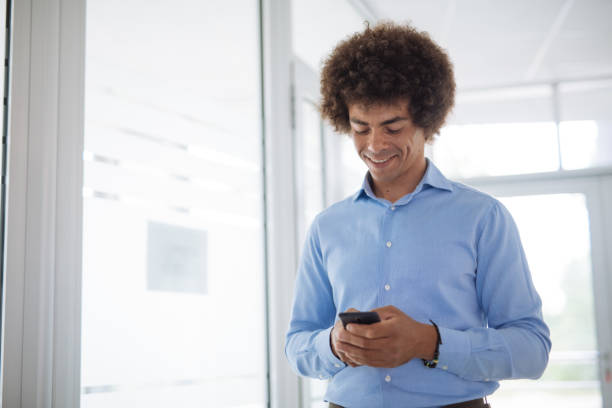 istock Mixed race African American businessman using smart phone in office 1321565691