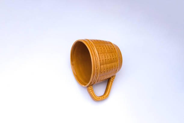 istock Empty yellow-brown cup with woven bamboo motif isolated on white background 1321567207
