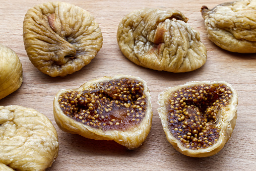 Tasty dried figs fruit on wooden table. Sweet natural dessert. Healthy eating and proper lifestyle.