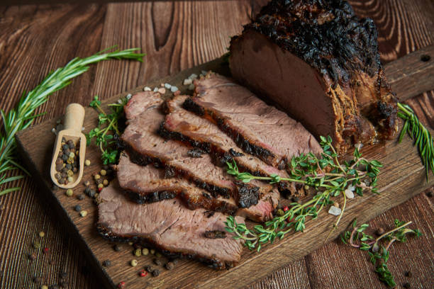 istock Roast beef on cutting board. Wooden background. 1321570425
