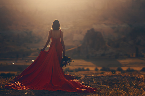 A woman in a red dress in Cappadocia