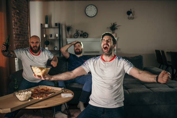 istock Friends watching sport on tv 1321574035