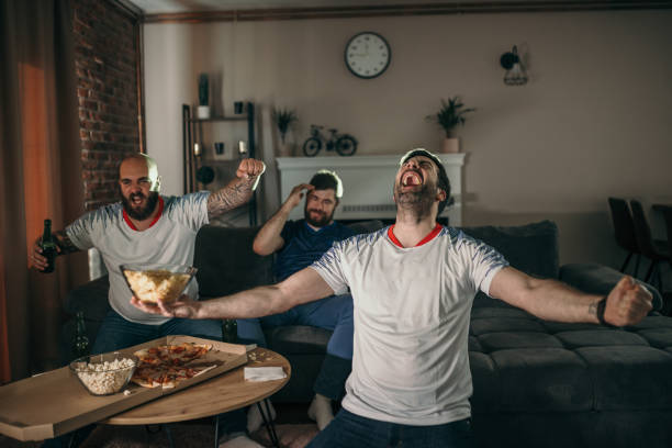 istock Friends watching sport on tv 1321574053