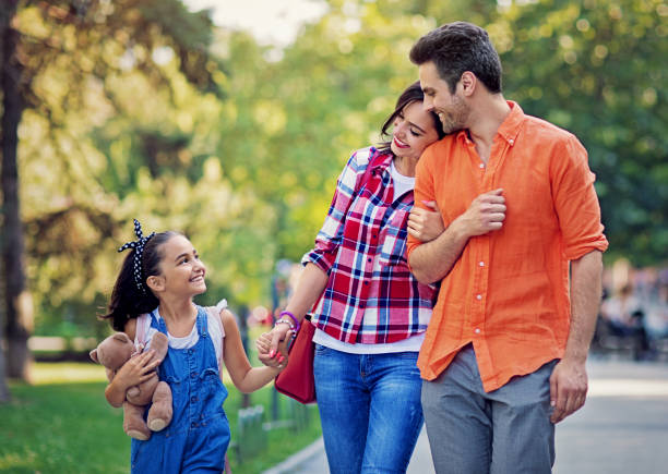 istock Happy family is walking in a park 1321575978