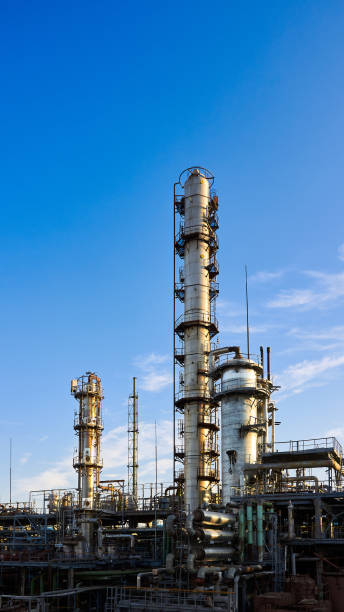 istock Old methanol distillation refinery column towers and reactors under blue evening sunset sky background at chemical plant. Exterior of silver metal rusty enterprise 16x9 vertical with copyspace. 1321577033