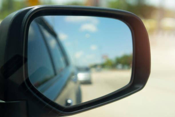 Abstract and blurred view of traffic from behind through the mirrors wing. stock photo