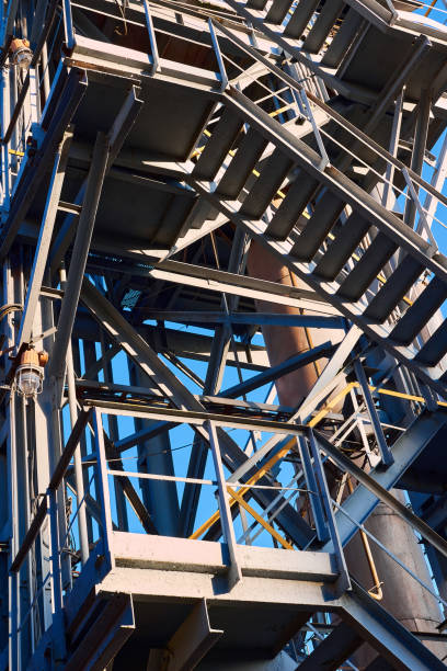 istock Industrial building structure fragment featuring metal staircases tubes and pillars. Abstract image concept of modern urban architecture industry and technology, vertical. 1321577402