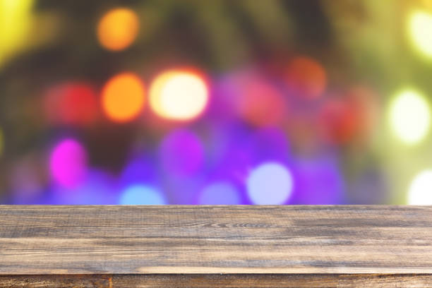 istock wood table top on blur christmas tree with garlands background 1321582510