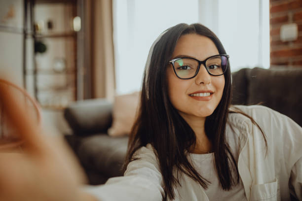 istock A young female student sitting on thek couch using laptop headphones when studying 1321583572