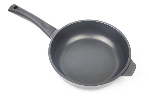 istock Black frying pan with non-stick teflon coating on white background 1321586161