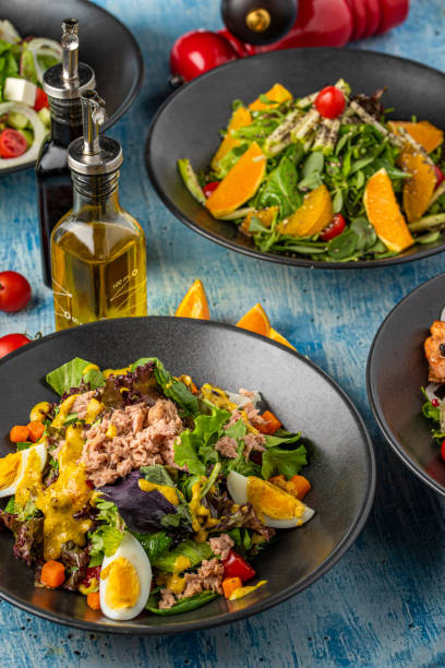 istock Four different types of salads served freshly on blue stone table 1321588489