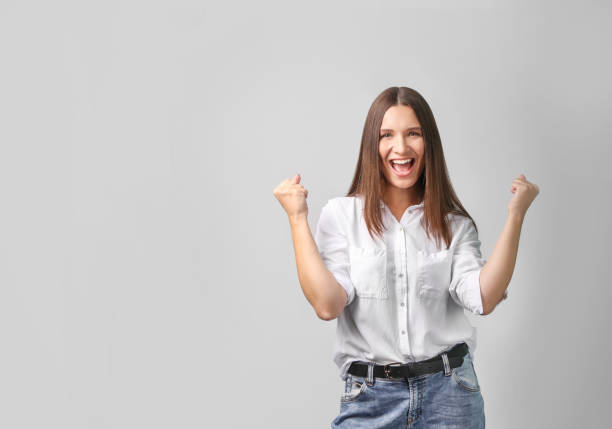 istock Successful beautiful young woman on grey background 1321598085